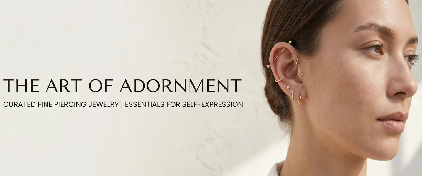 Woman wearing earrings piercing jewelry with text 'The Art of Adornment' on a light background